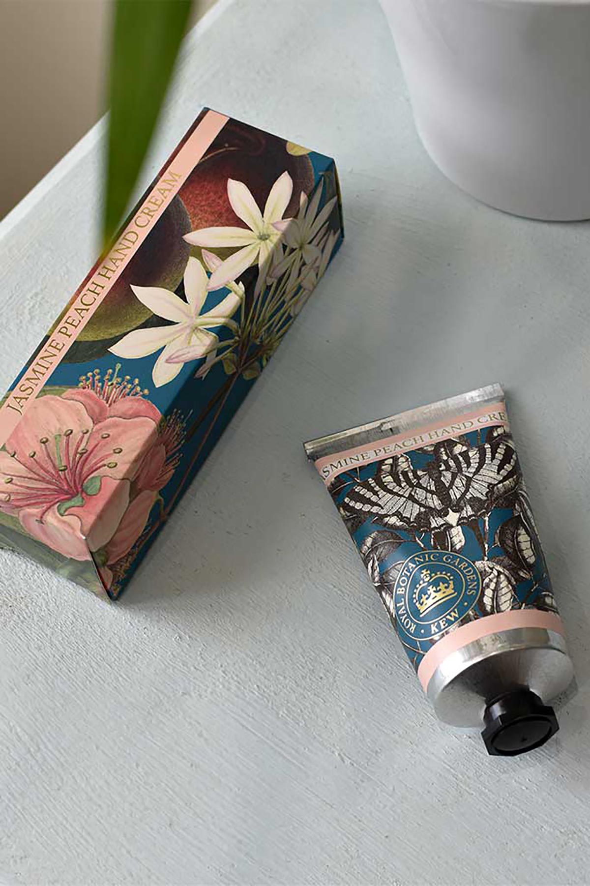 Close-up detail of Kew Gardens Jasmine Peach Hand Cream floral tube design