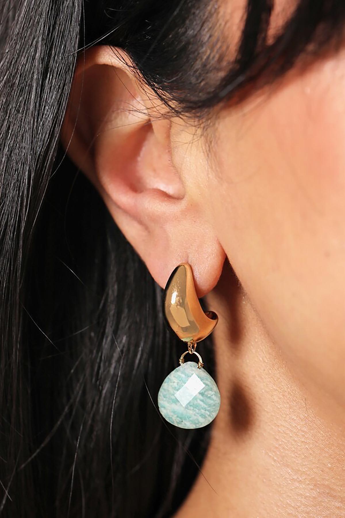 Close-up of amazonite fossil earrings