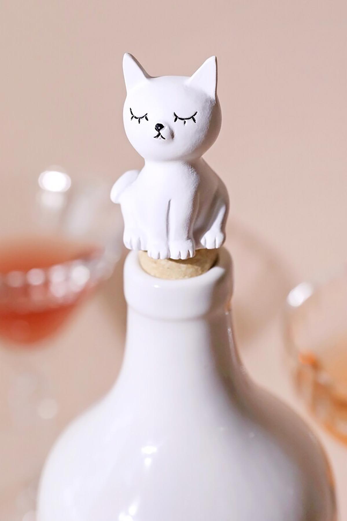 Cat bottle stopper placed in glass bottle