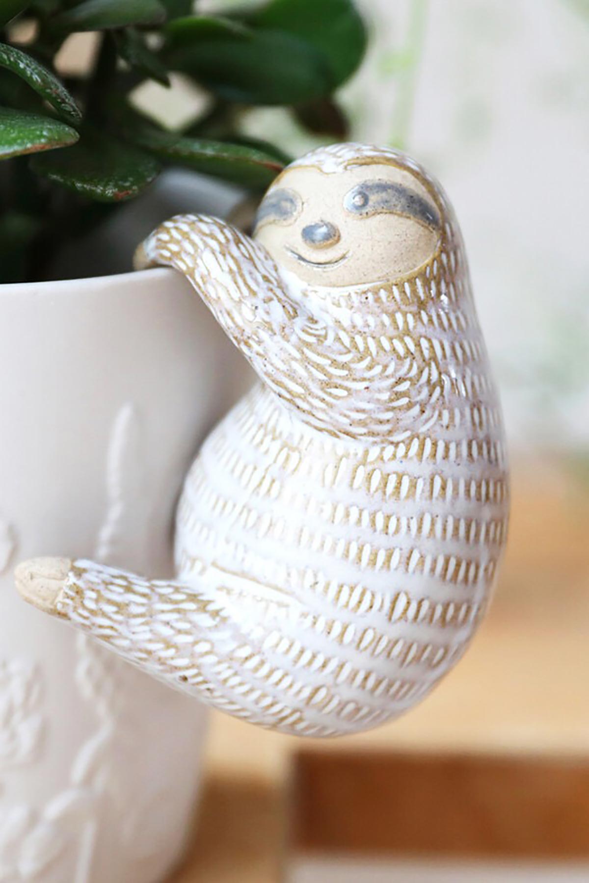 Close-up of sloth planter accessory