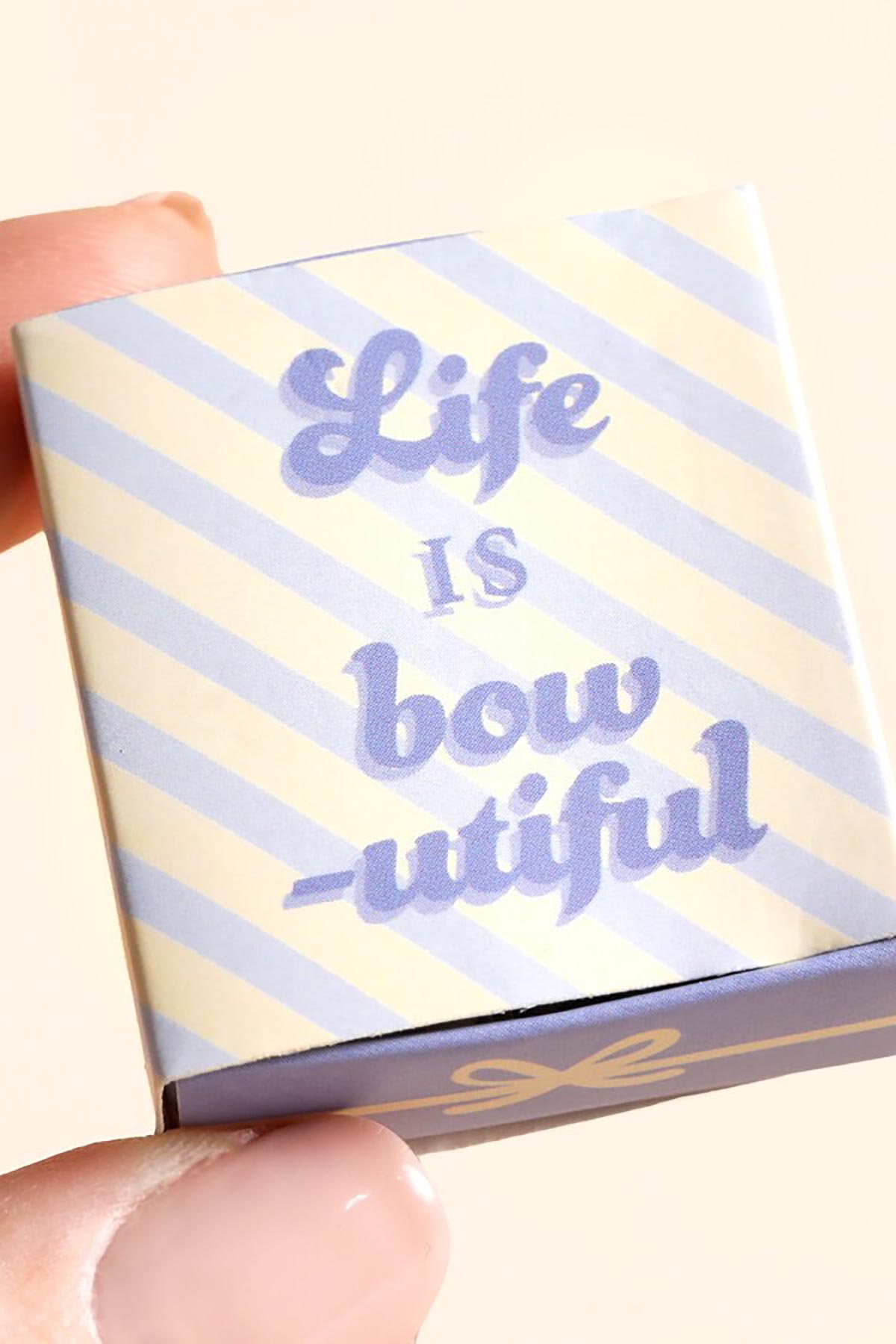 Bow ceramic token styled as a gift
