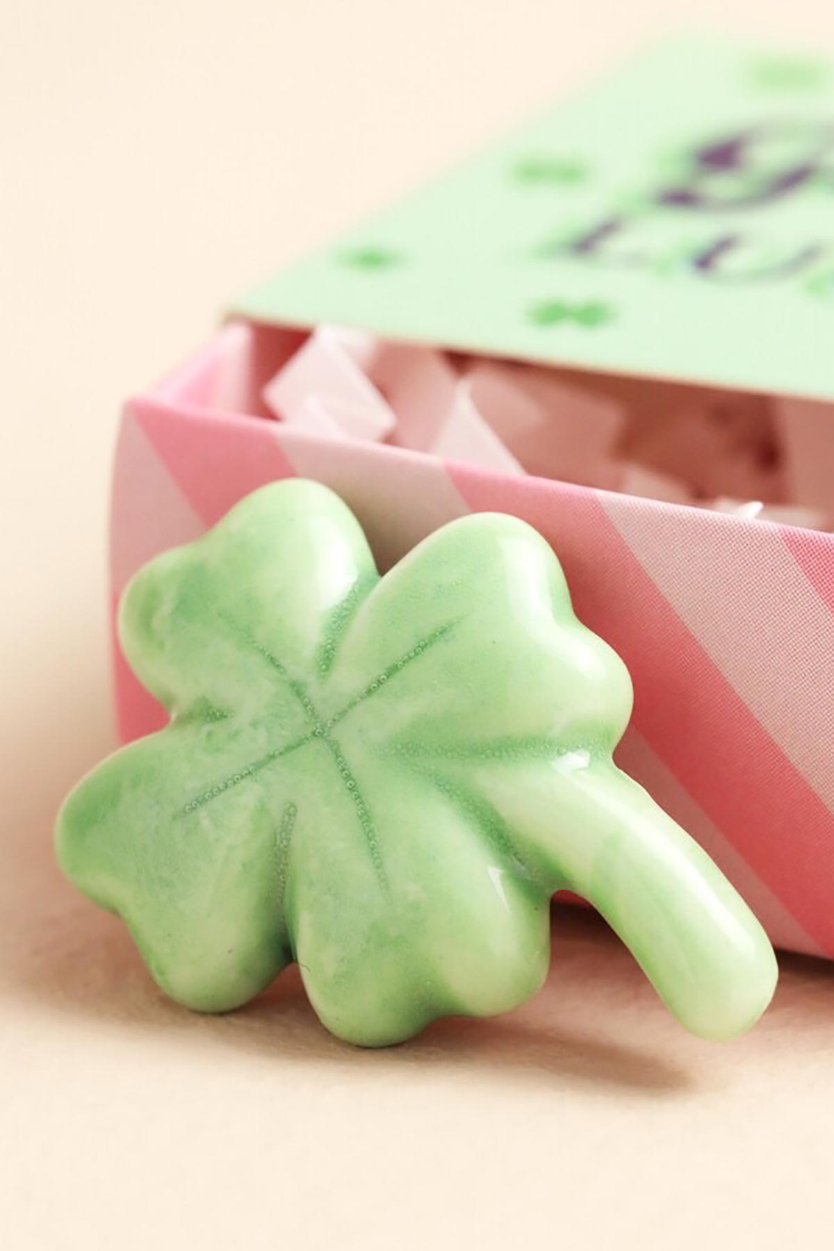 Ceramic clover token displayed outside matchbox