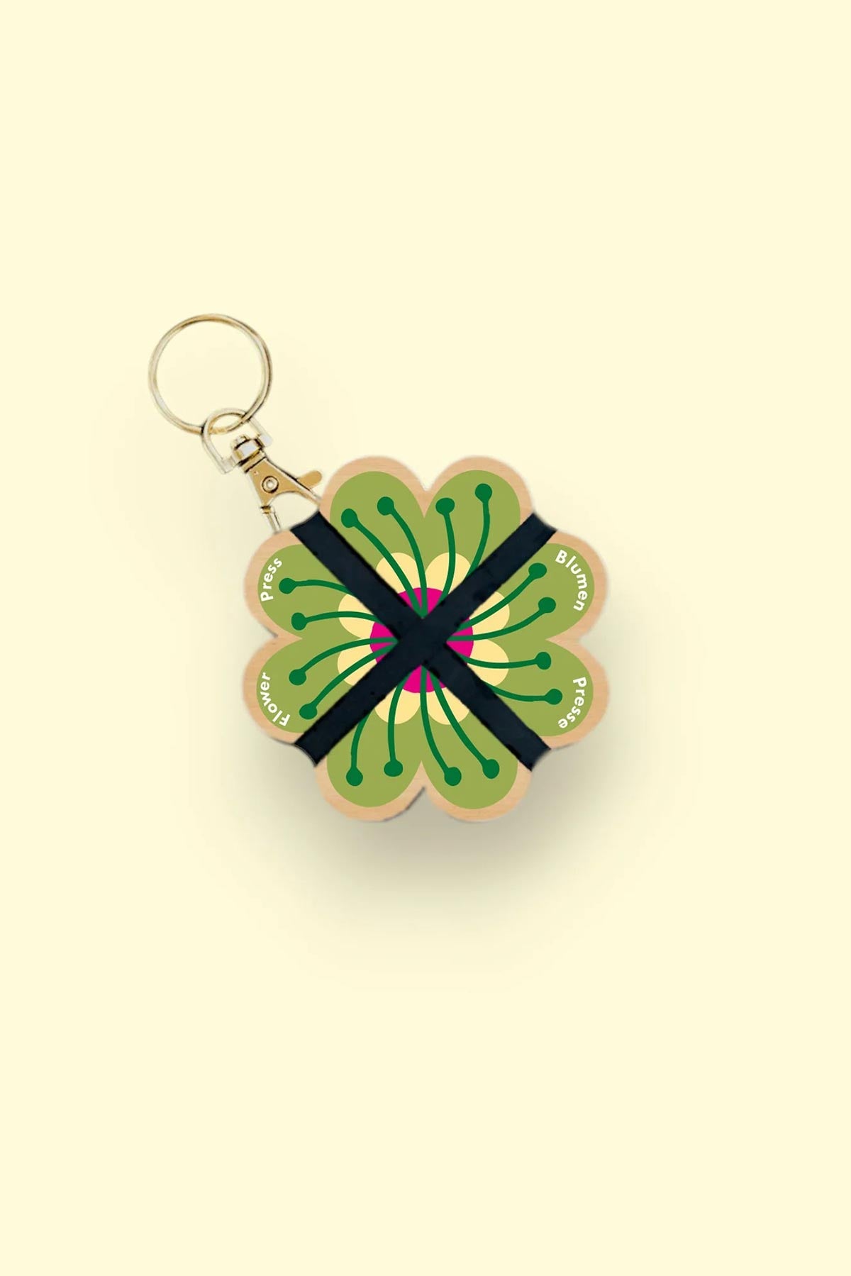 Nature lover using Studio Wald mini flower press outdoors keyring