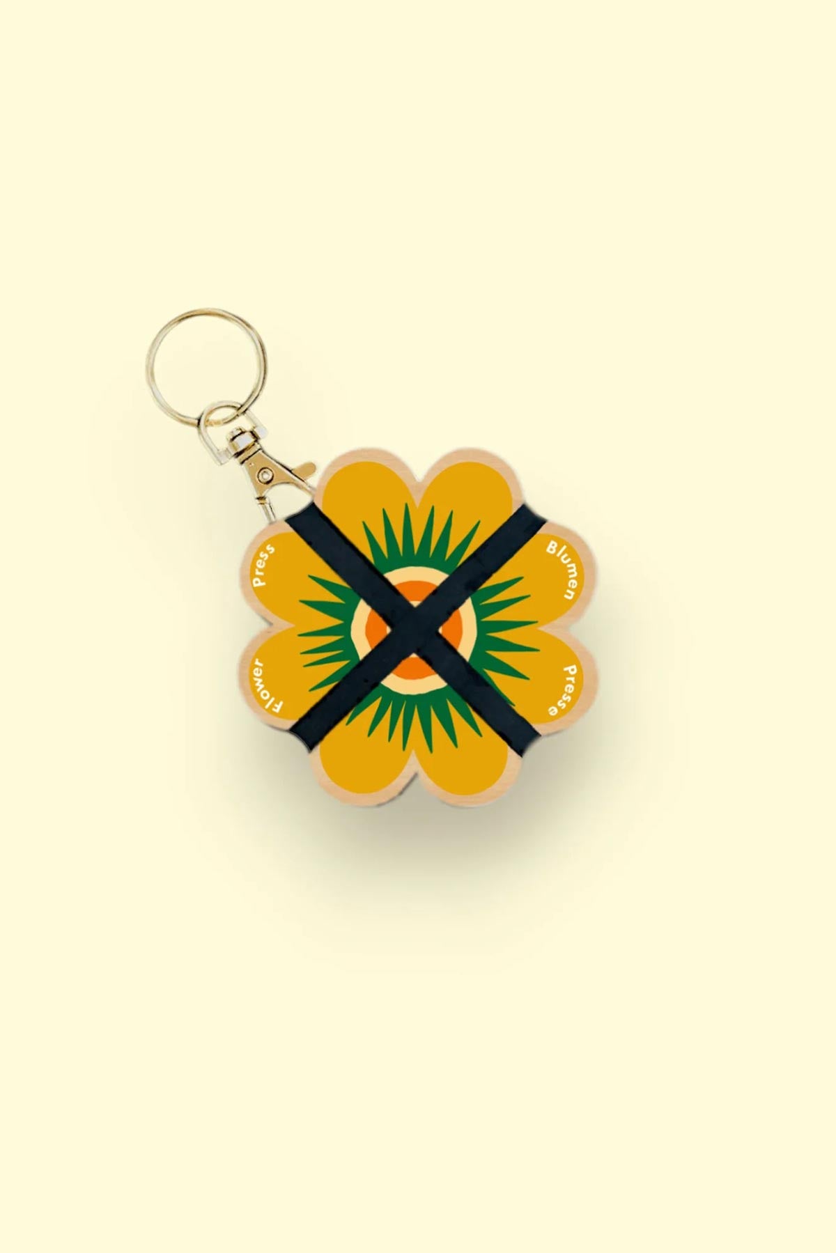 Nature lover using Studio Wald mini flower press outdoors keyring