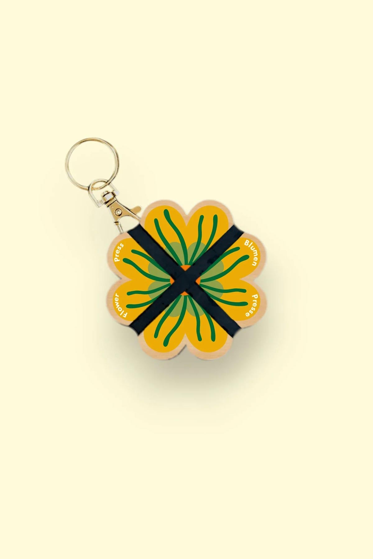 Nature lover using Studio Wald mini flower press outdoors keyring