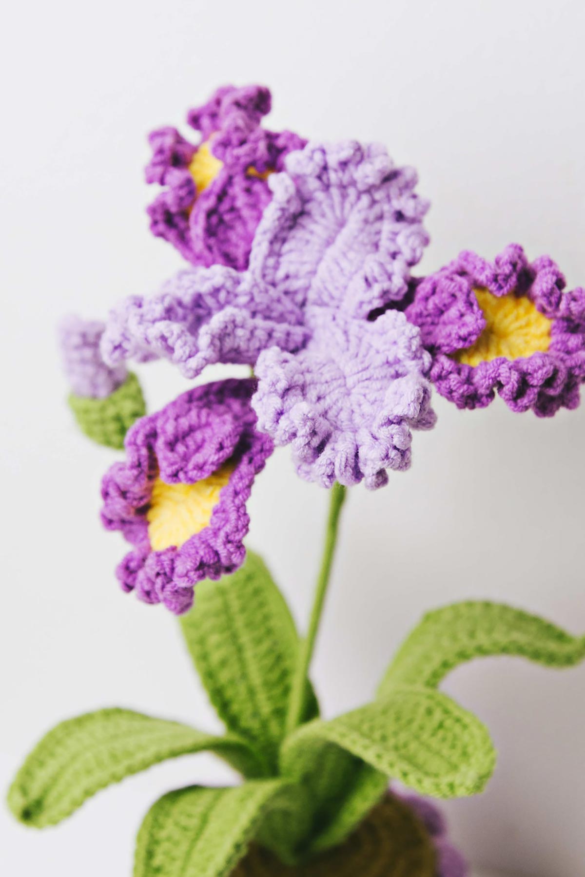 Crochet iris detail showing purple petals and yellow center