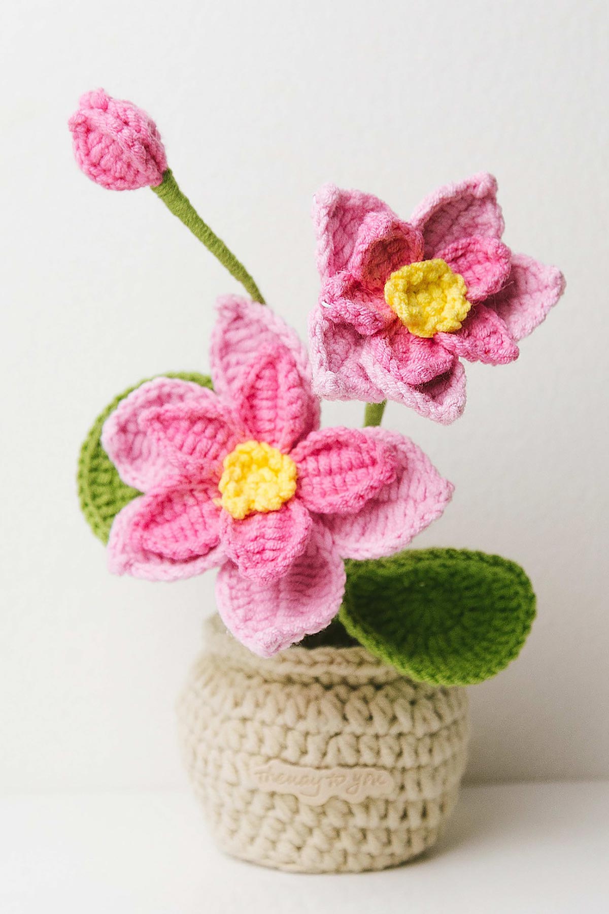 The Way to You Lotus crochet flower with pink petals and yellow center
