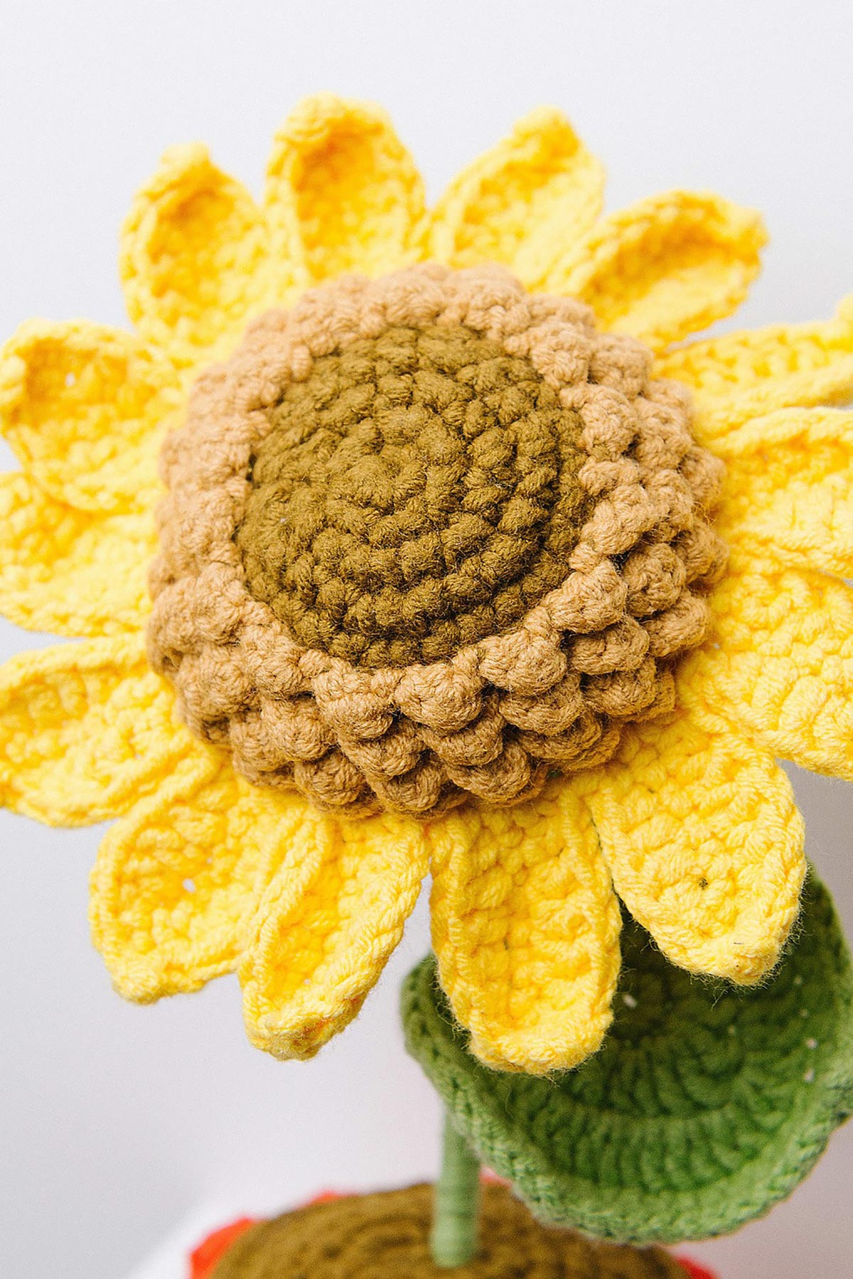Crochet sunflower detail showing yellow petals and brown center