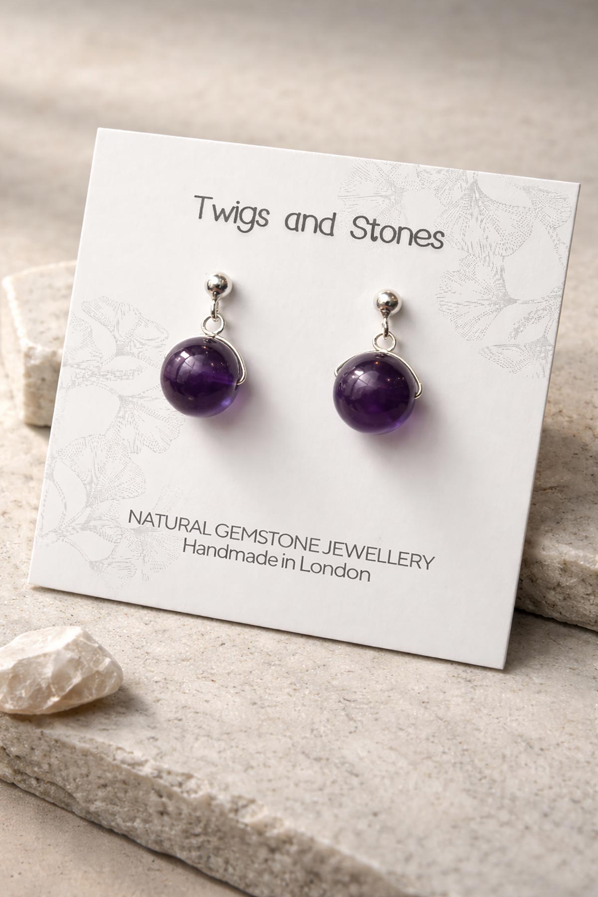 Close-up of amethyst gemstone stud earrings