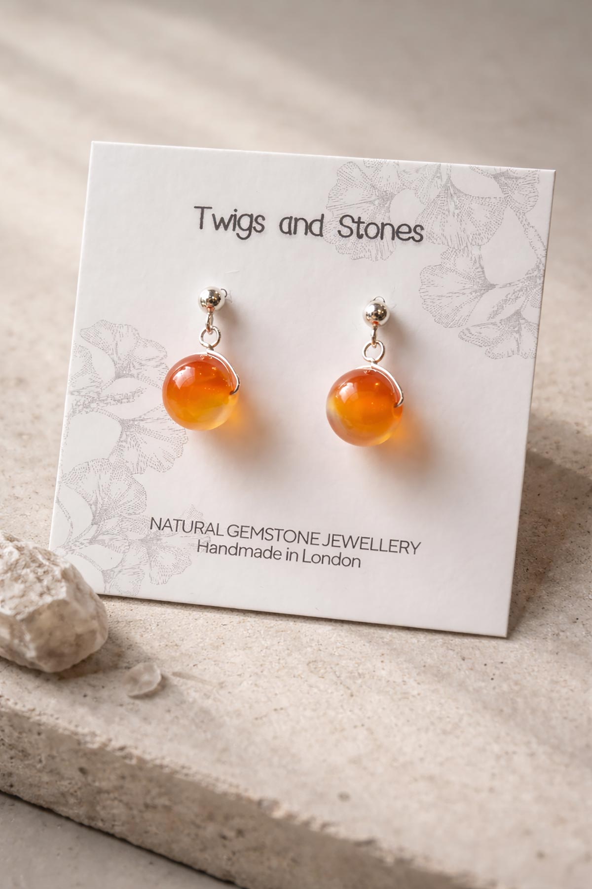 Close-up of carnelian gemstone stud earrings
