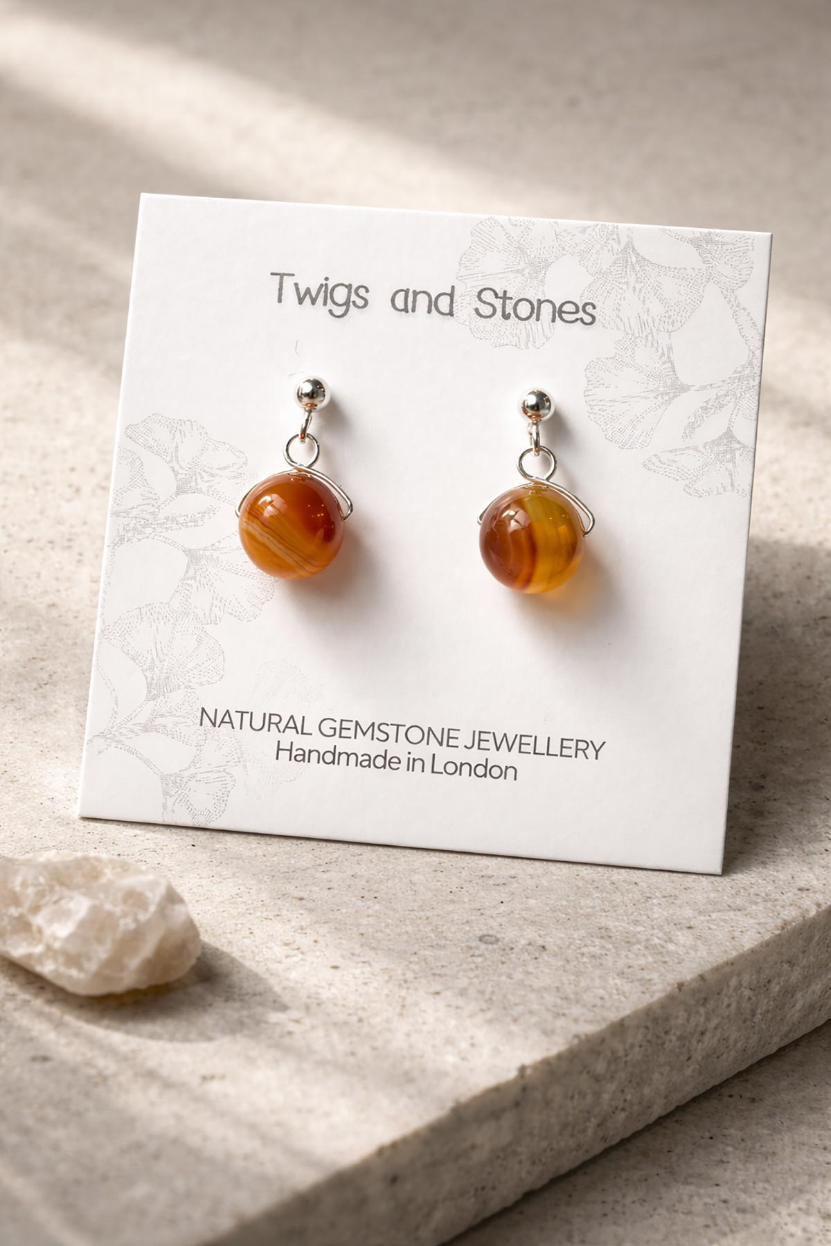 Close-up of golden brown agate gemstone stud earrings