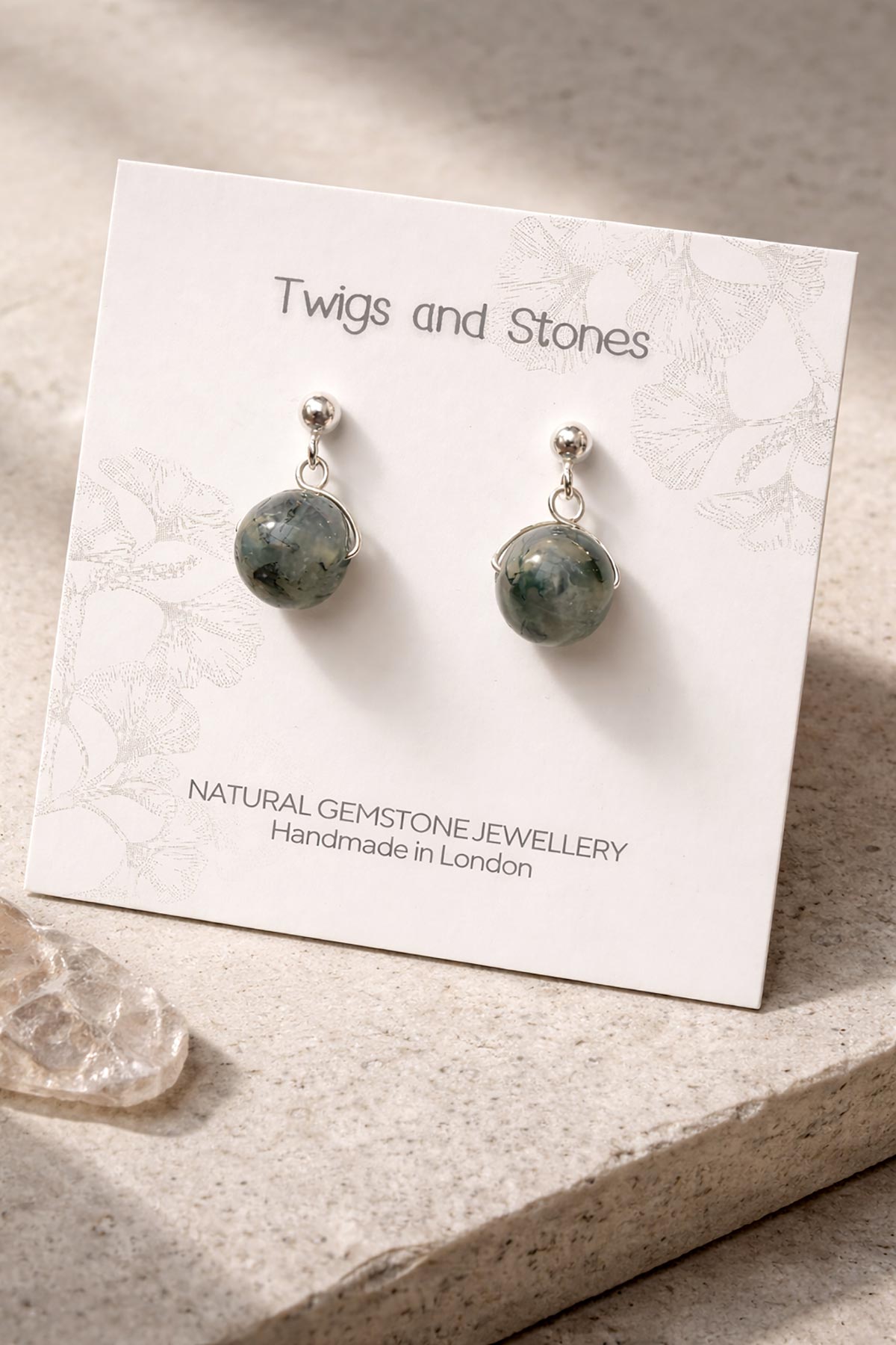 Close-up of moss agate gemstone stud earrings
