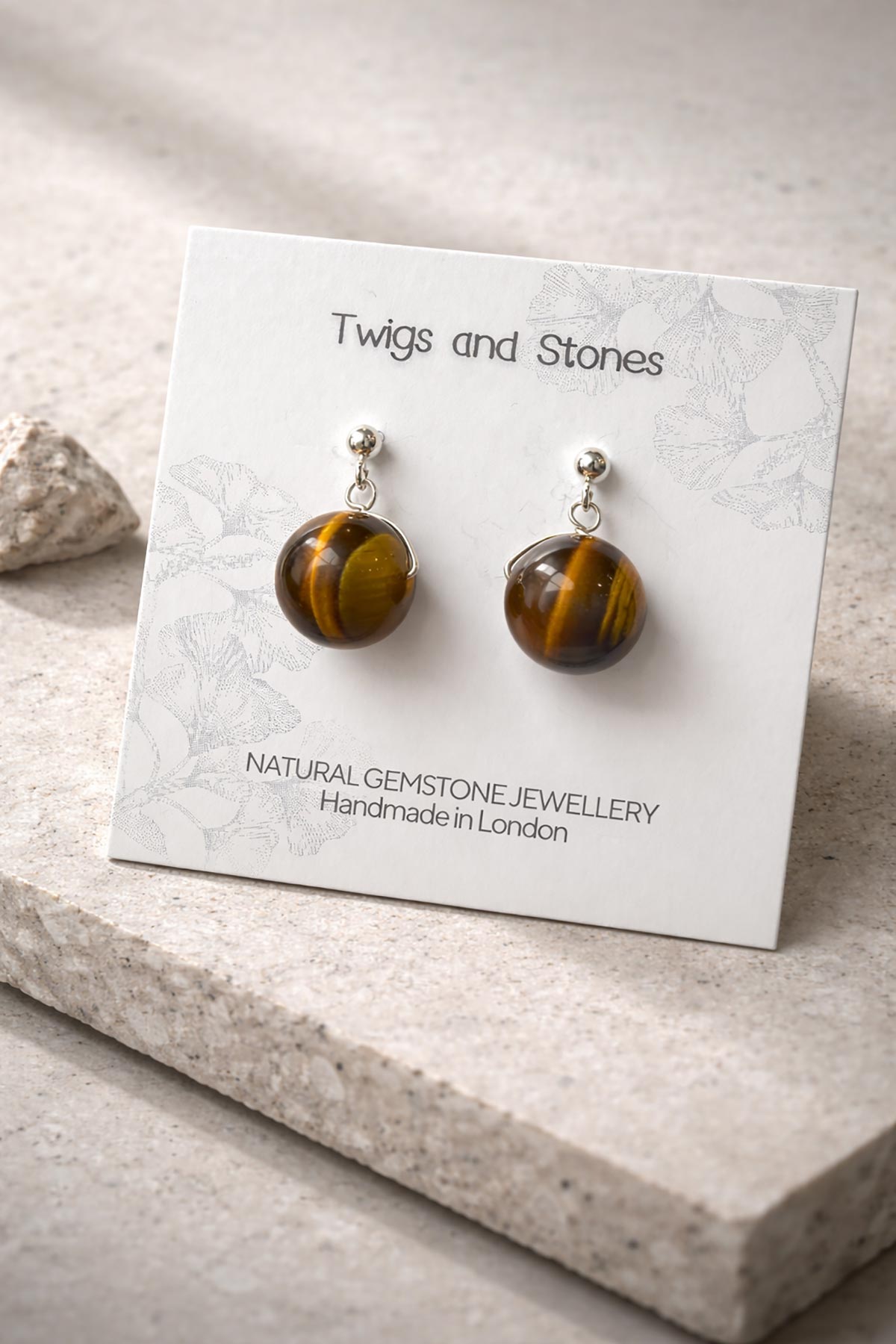 Close-up of tiger’s eye gemstone stud earrings