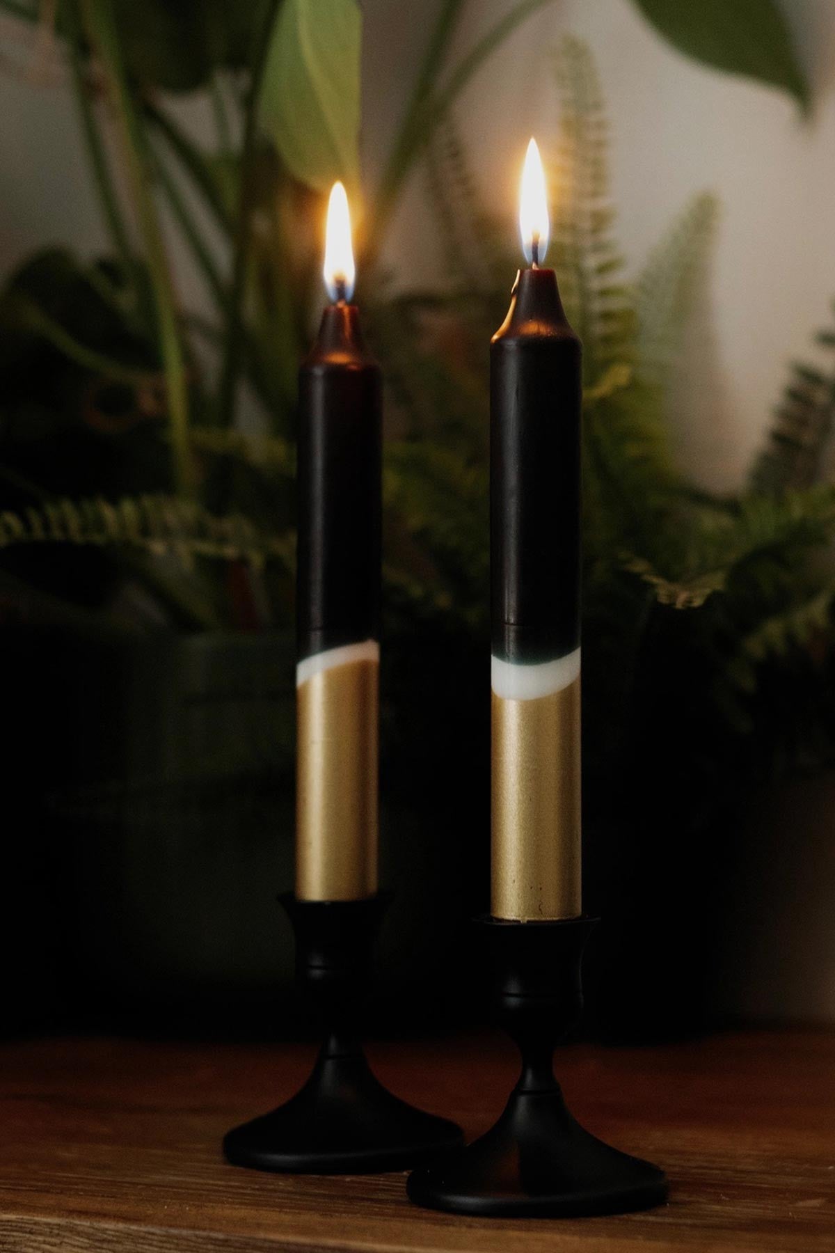 The Singing Rabbit black gold taper candles styled on dining table — Urban Wild