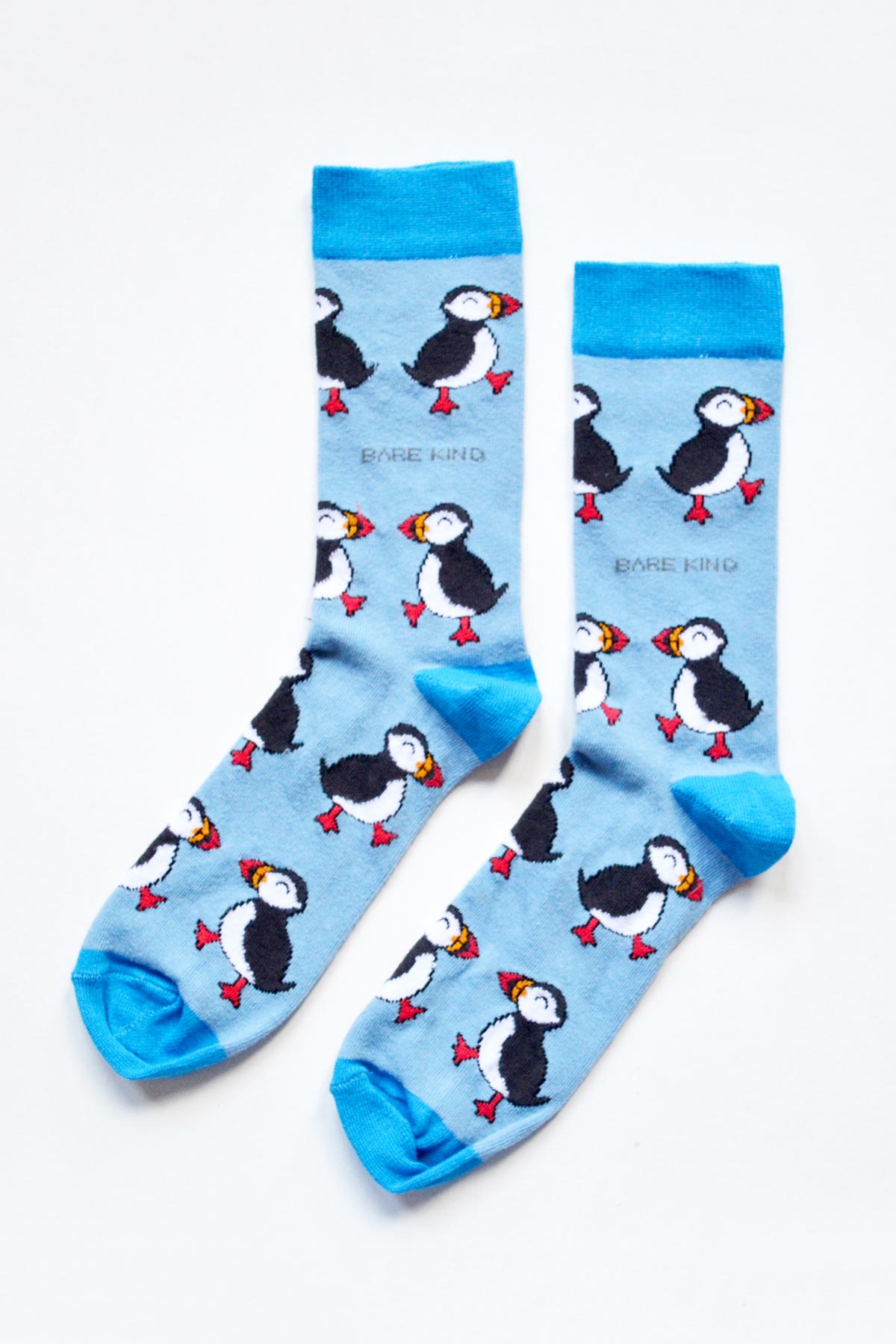 Pair of blue bamboo puffin crew socks laid flat showing all over puffin design from Urban Wild