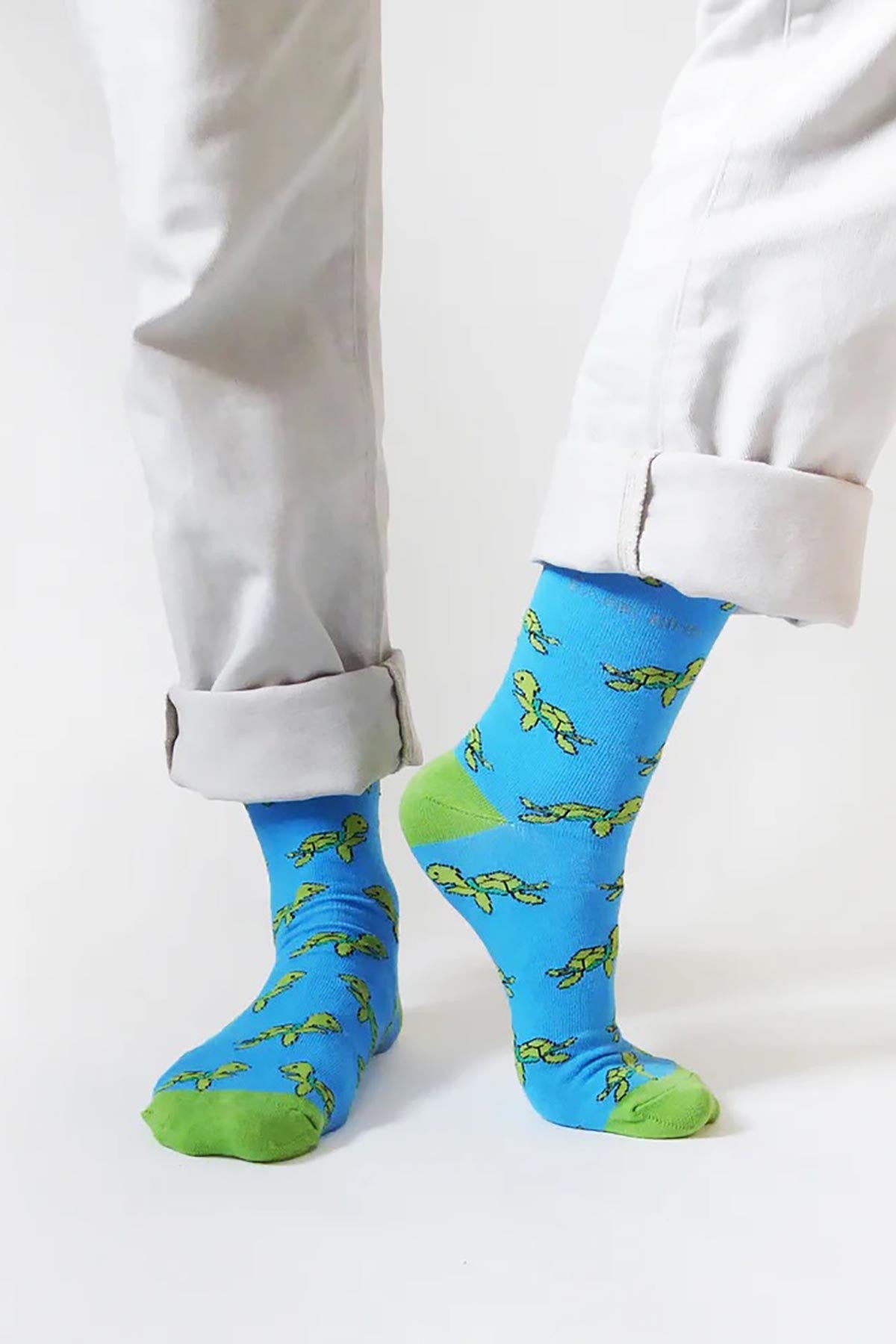 Sky blue bamboo crew socks with green turtle pattern worn with cream chinos — Urban Wild