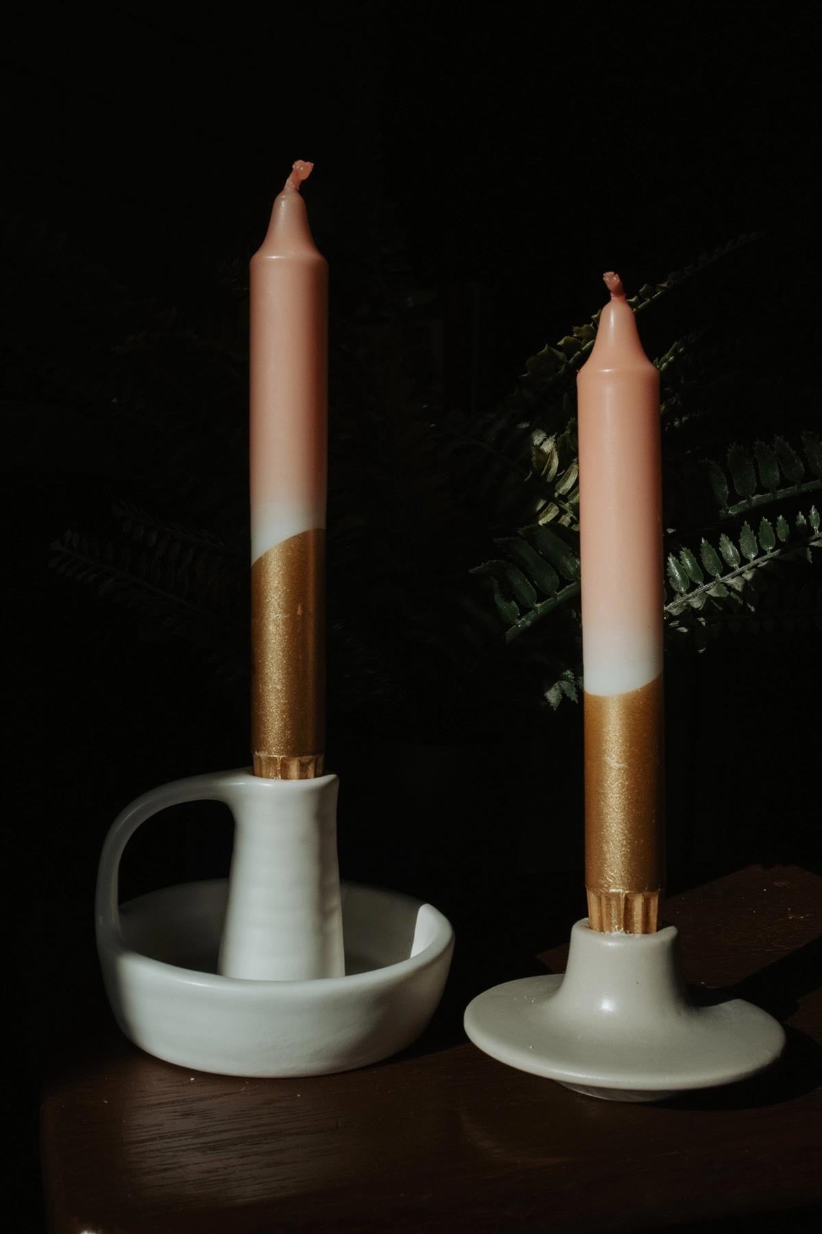 Pair of blush pink taper candles with gold dipped tips styled on table — Urban Wild