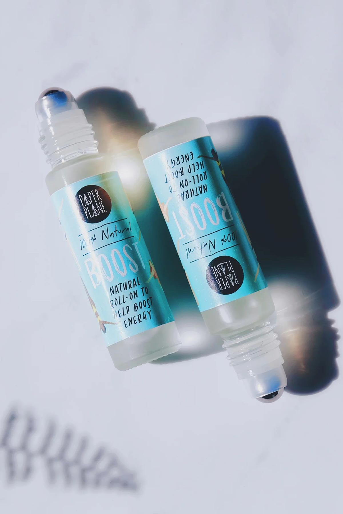 Two Boost natural energy roller oil bottles flatlay with reflection — Urban Wild