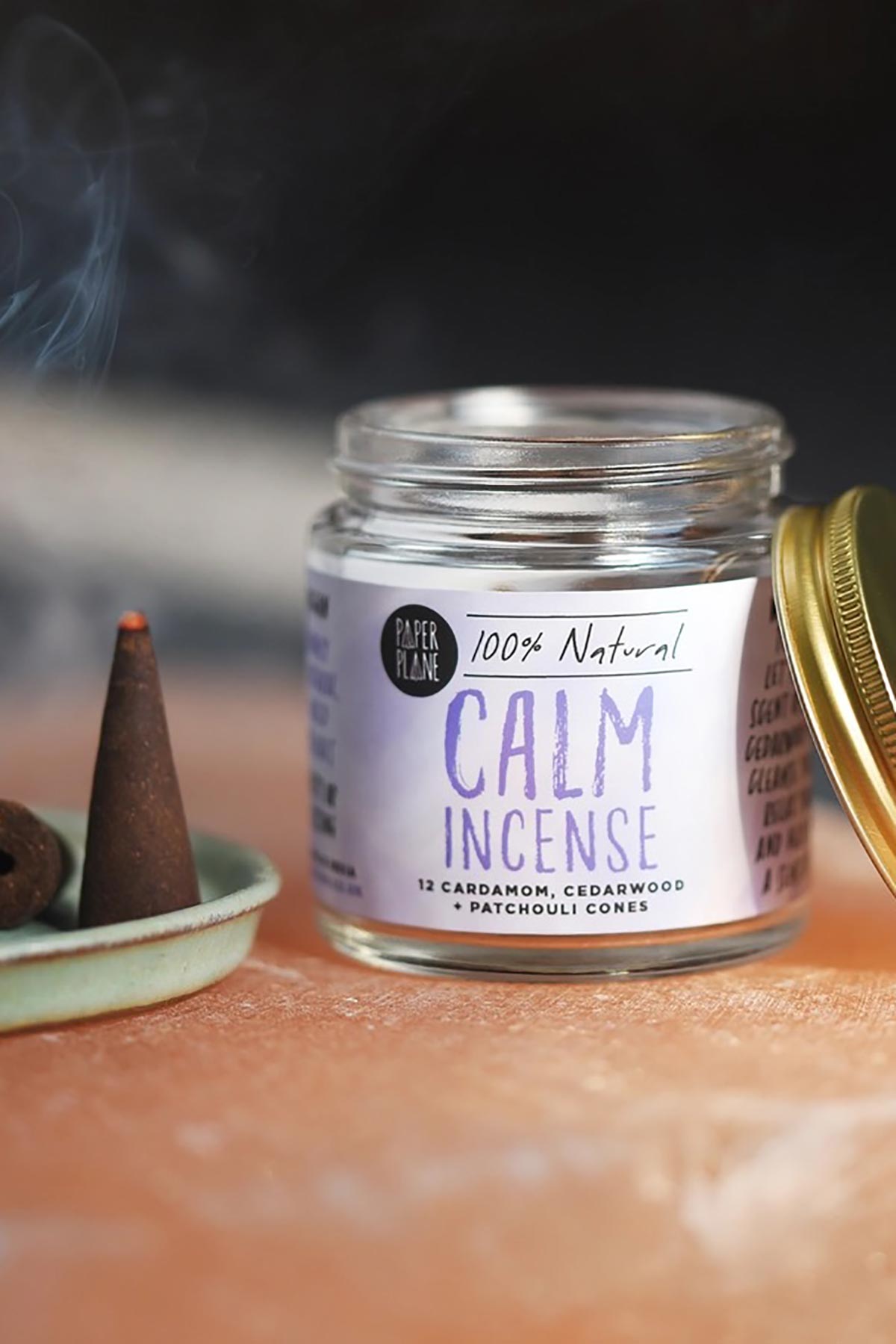Paper Plane Calm natural incense cone burning with curling smoke beside glass jar — Urban Wild