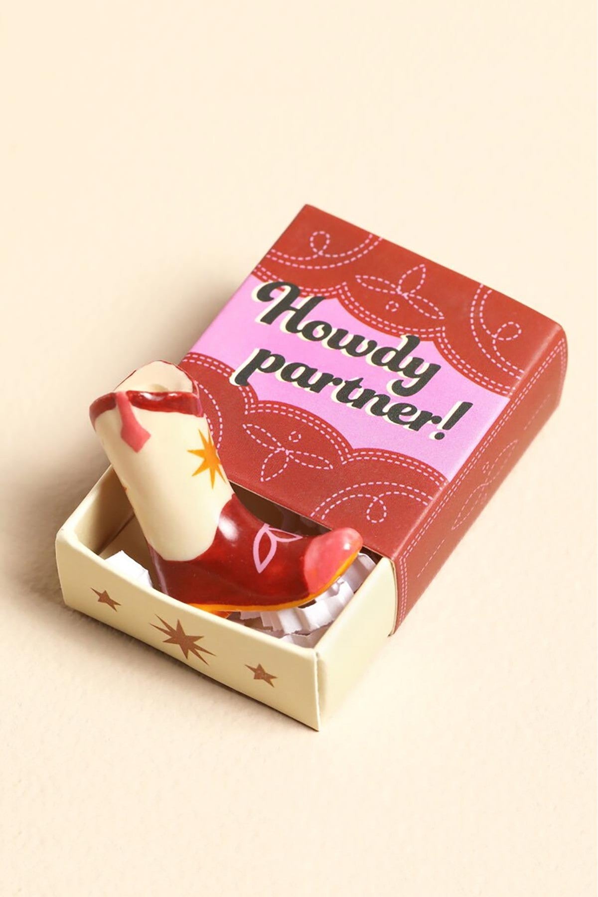 Tiny ceramic cowboy boot token in pink brown and cream inside Howdy Partner matchbox — Urban Wild