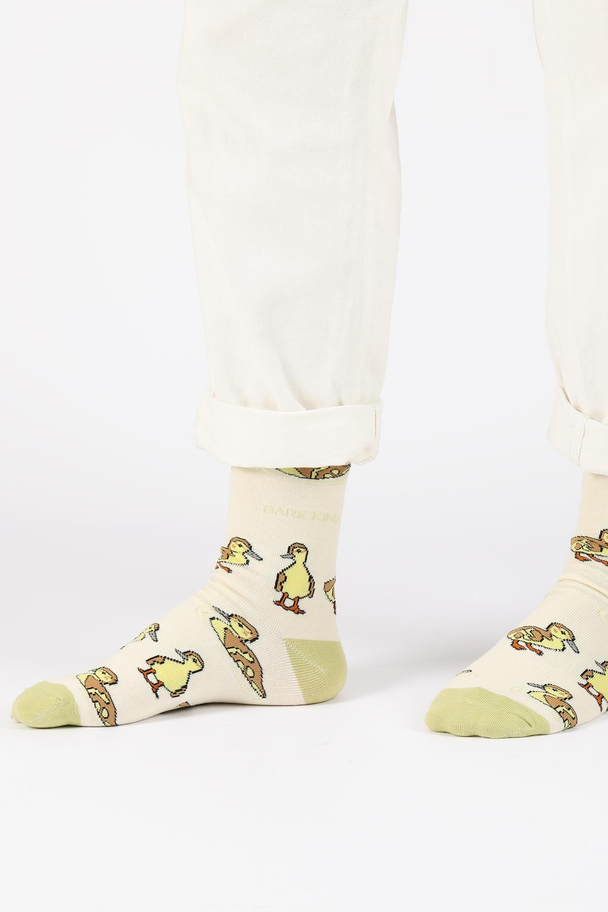 Cream duckling bamboo crew socks worn with rolled cream trousers showing sage toe and cuff — Urban Wild