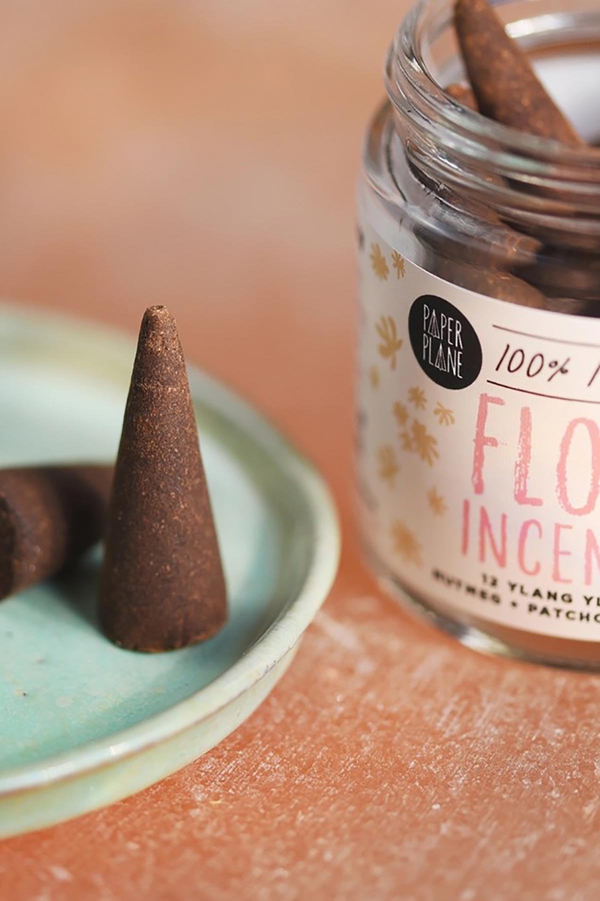 Close up of plant-based Flow incense cone with ylang ylang patchouli jar — Urban Wild