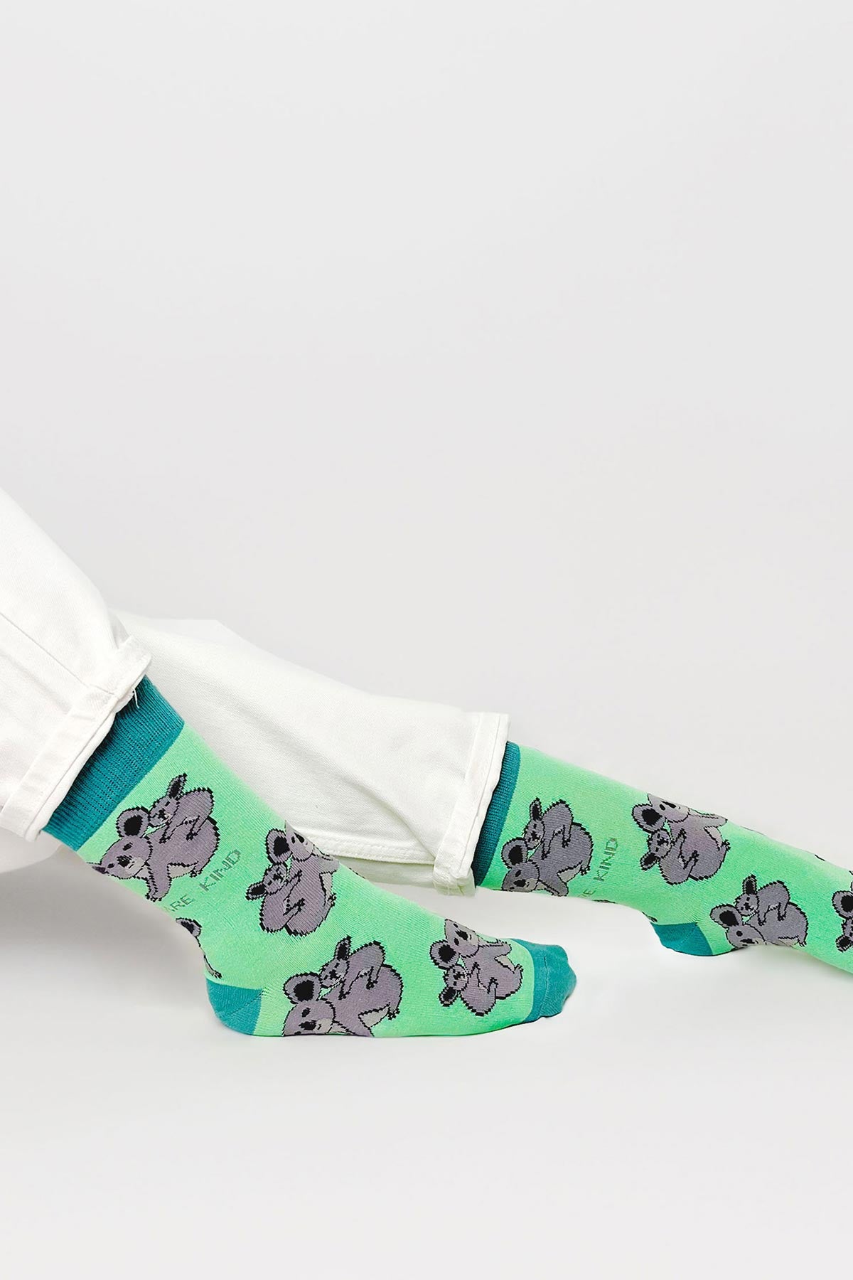 Mint green koala bamboo crew socks worn with white jeans — Urban Wild