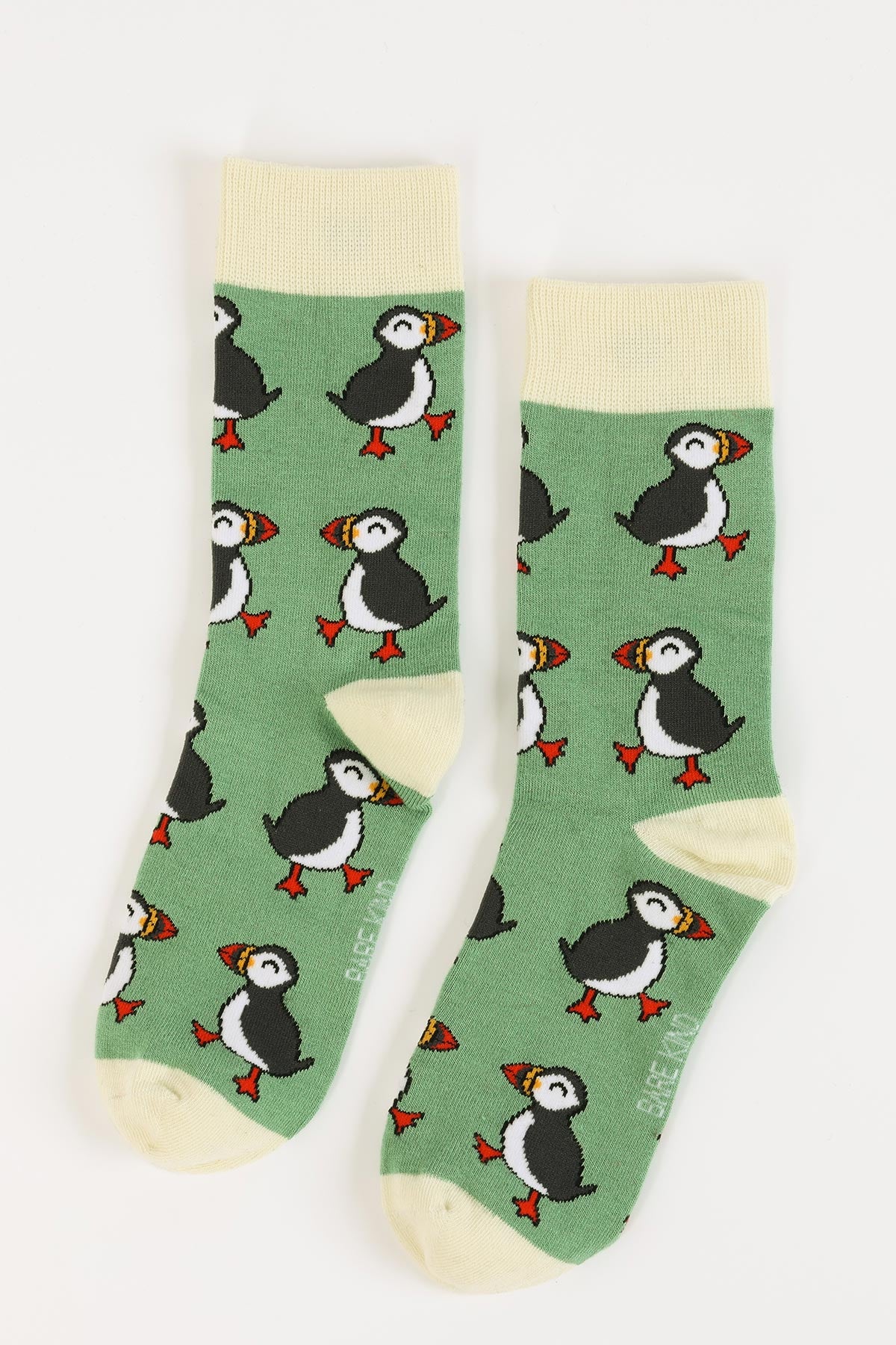 Pair of green bamboo crew socks with all-over puffin design and cream toes — Urban Wild