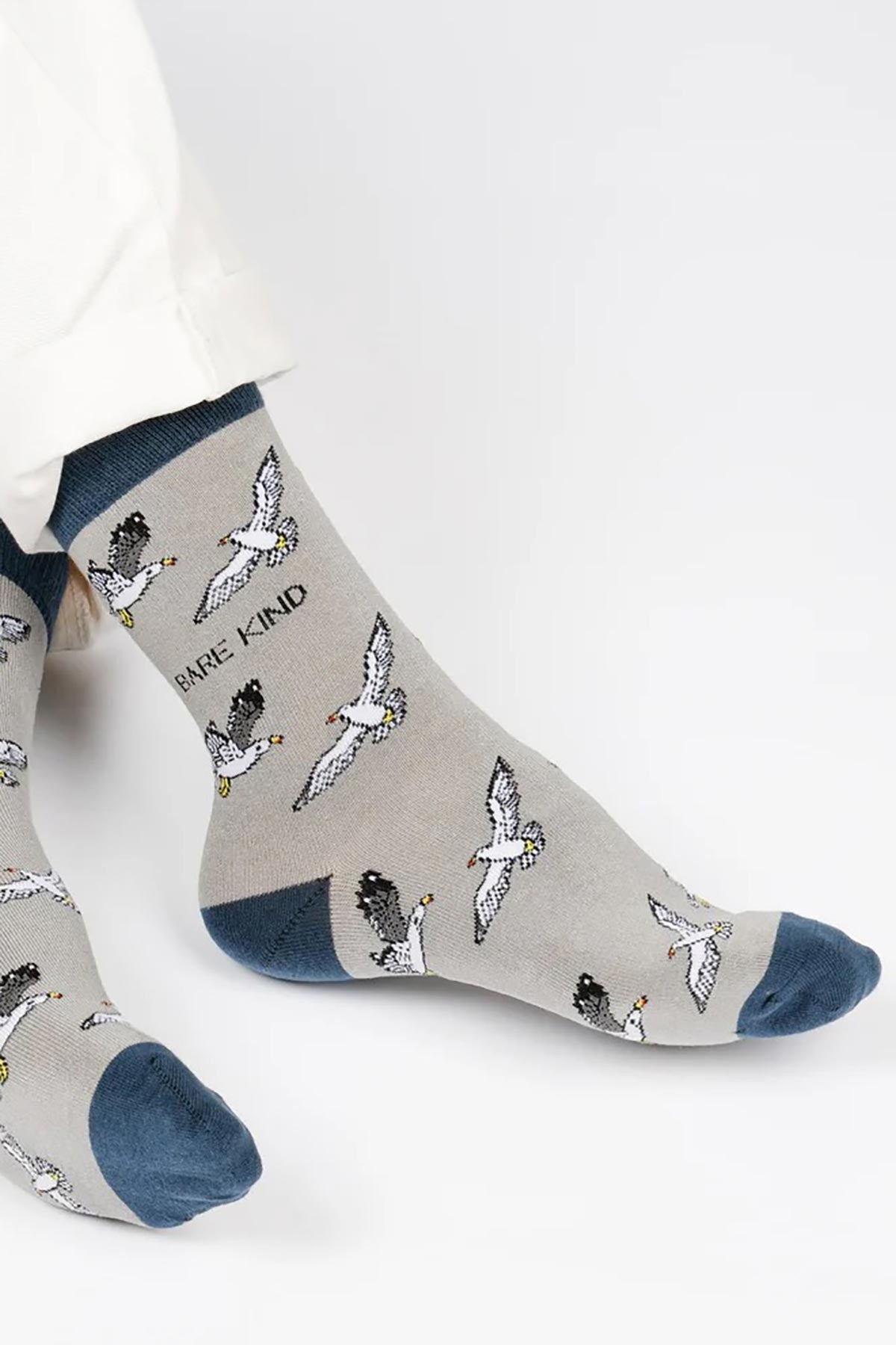 Grey bamboo crew socks with seagull pattern and navy cuffs worn with cream trousers — Urban Wild