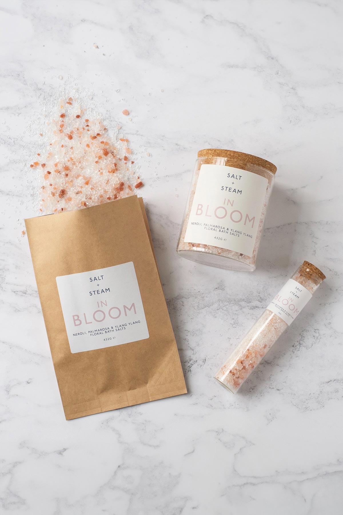 In Bloom floral bath salts with rose, neroli and palmarosa shown in jar, refill bag and bath shot — Urban Wild