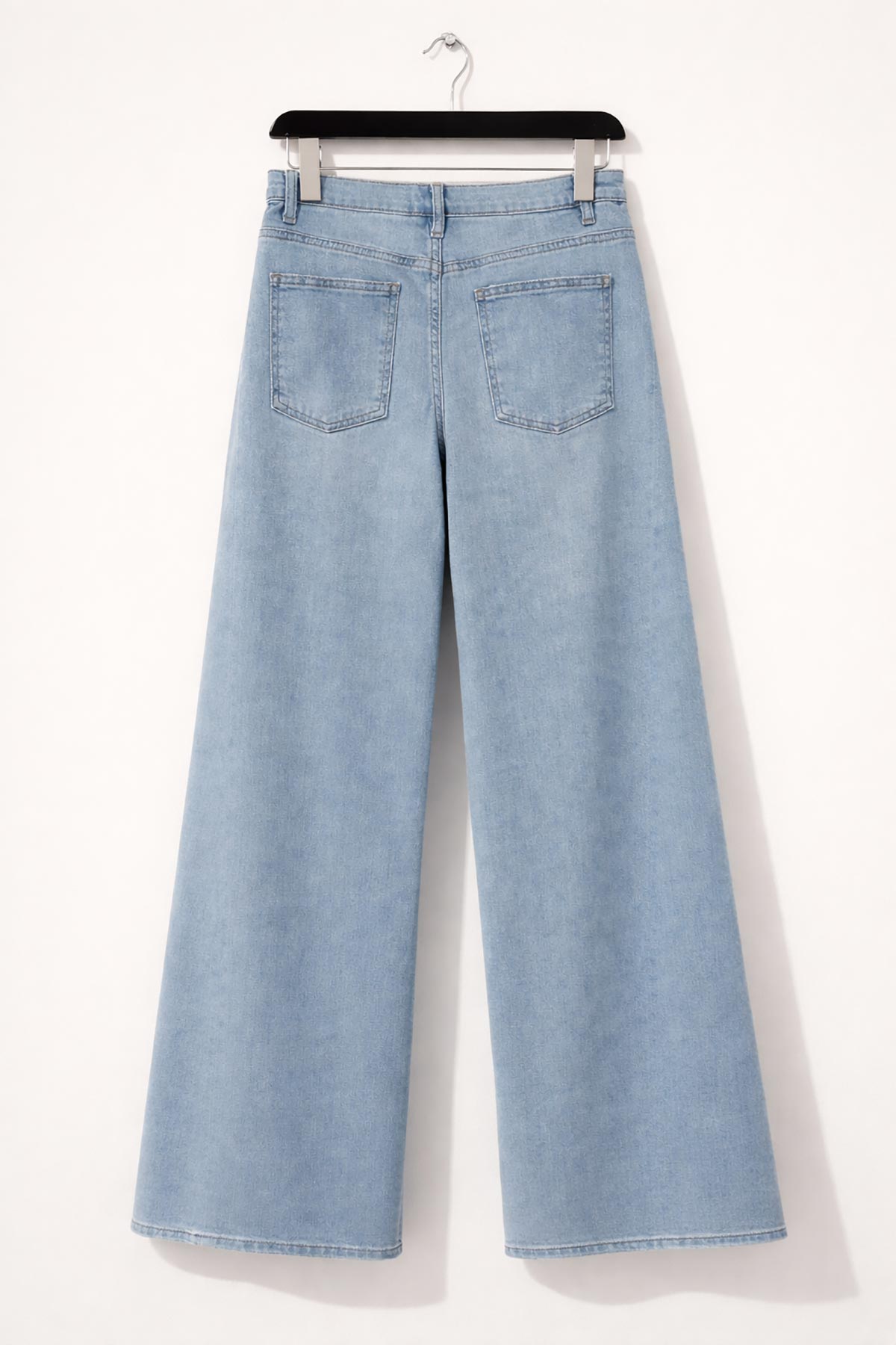 Detail of panel seam on light wash denim