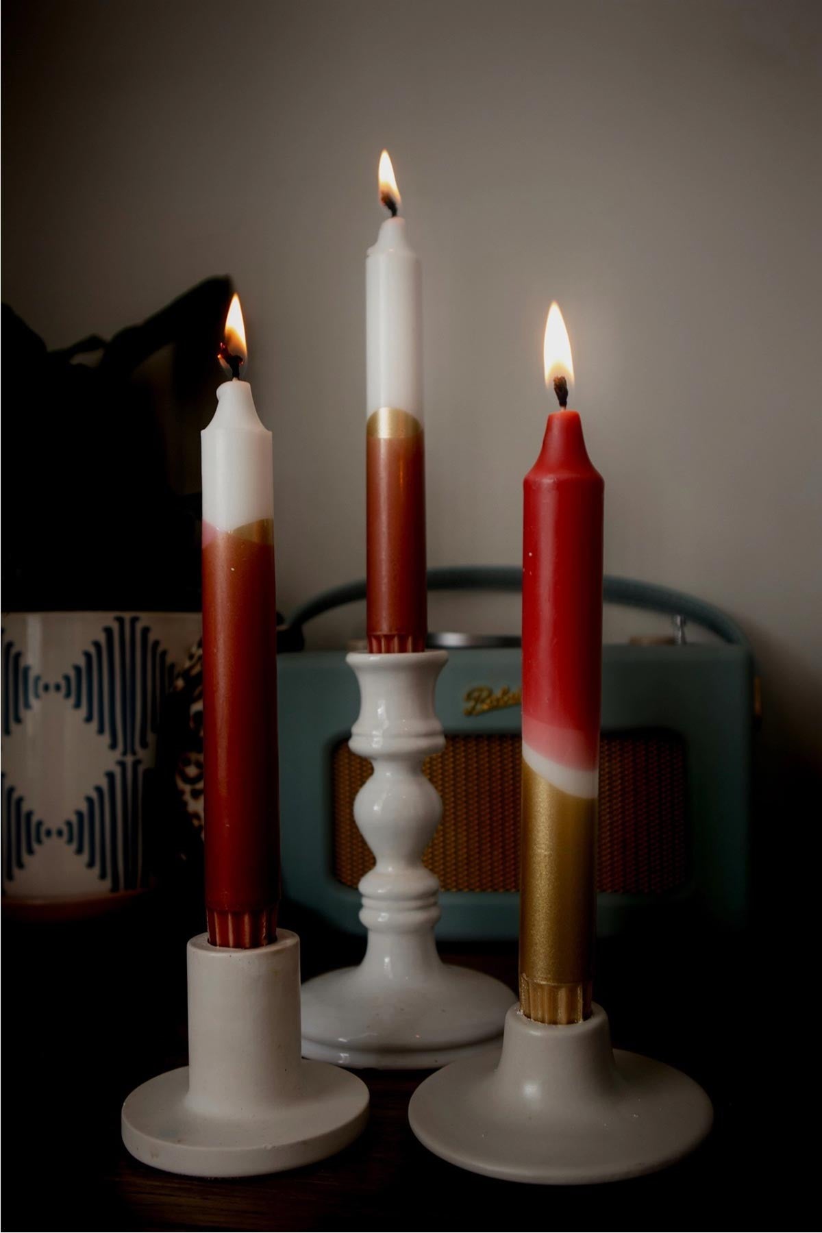 The Singing Rabbit red and gold taper candles styled on festive table setting — Urban Wild