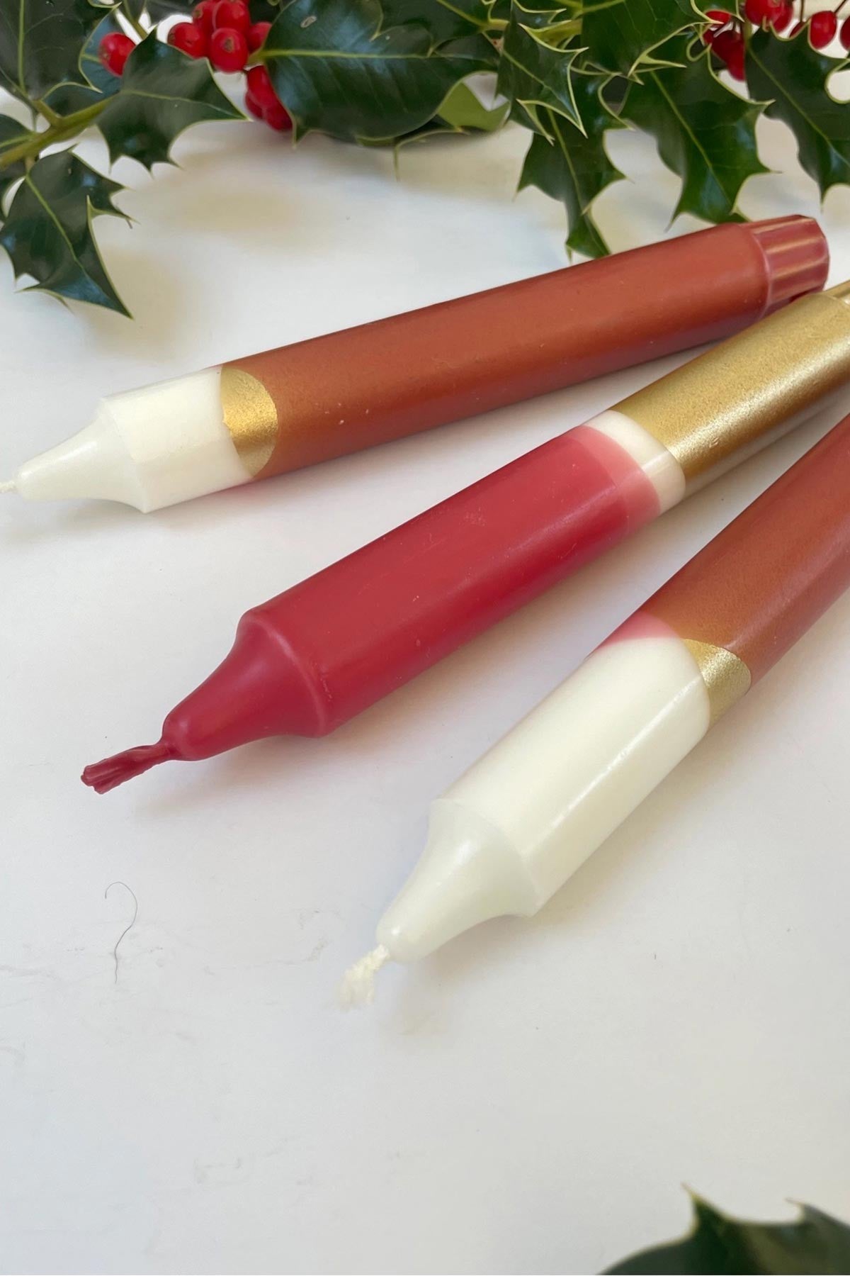 Hand dipped red and gold dinner candles showing unique colour detail — Urban Wild