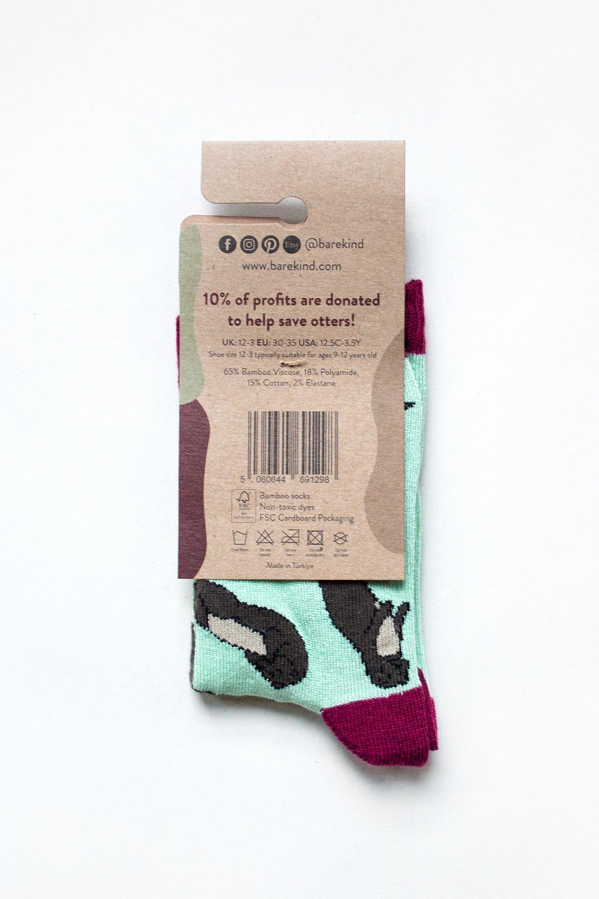 Back of Bare Kind otter bamboo socks packaging showing materials and charity donation — Urban Wild
