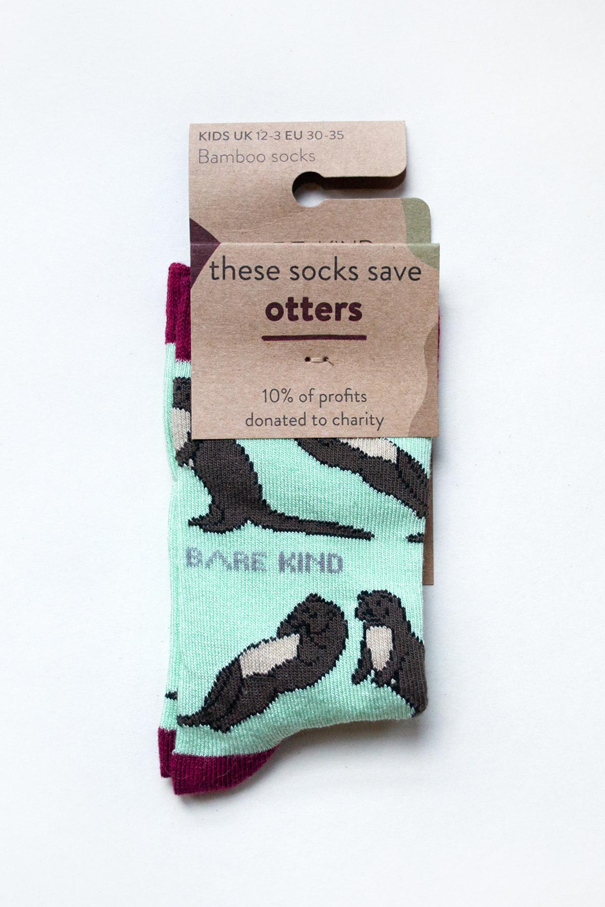 Mint green bamboo kids socks with otter pattern and burgundy cuff in Bare Kind packaging — Urban Wild