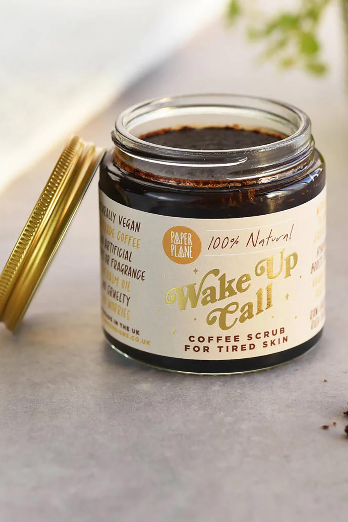 Natural coffee body and face scrub in amber glass jar with gold lid open showing grounds — Urban Wild