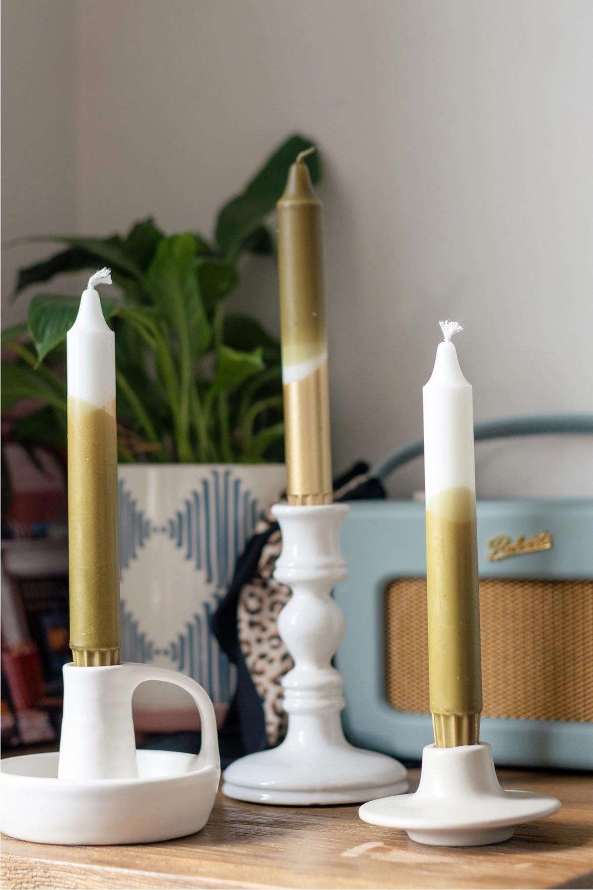 Luxe olive green and gold taper candles styled on a dining table — Urban Wild