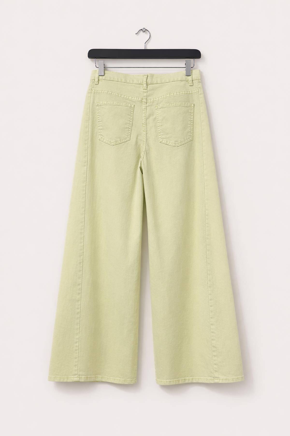 Detail of panel seam on pale yellow denim