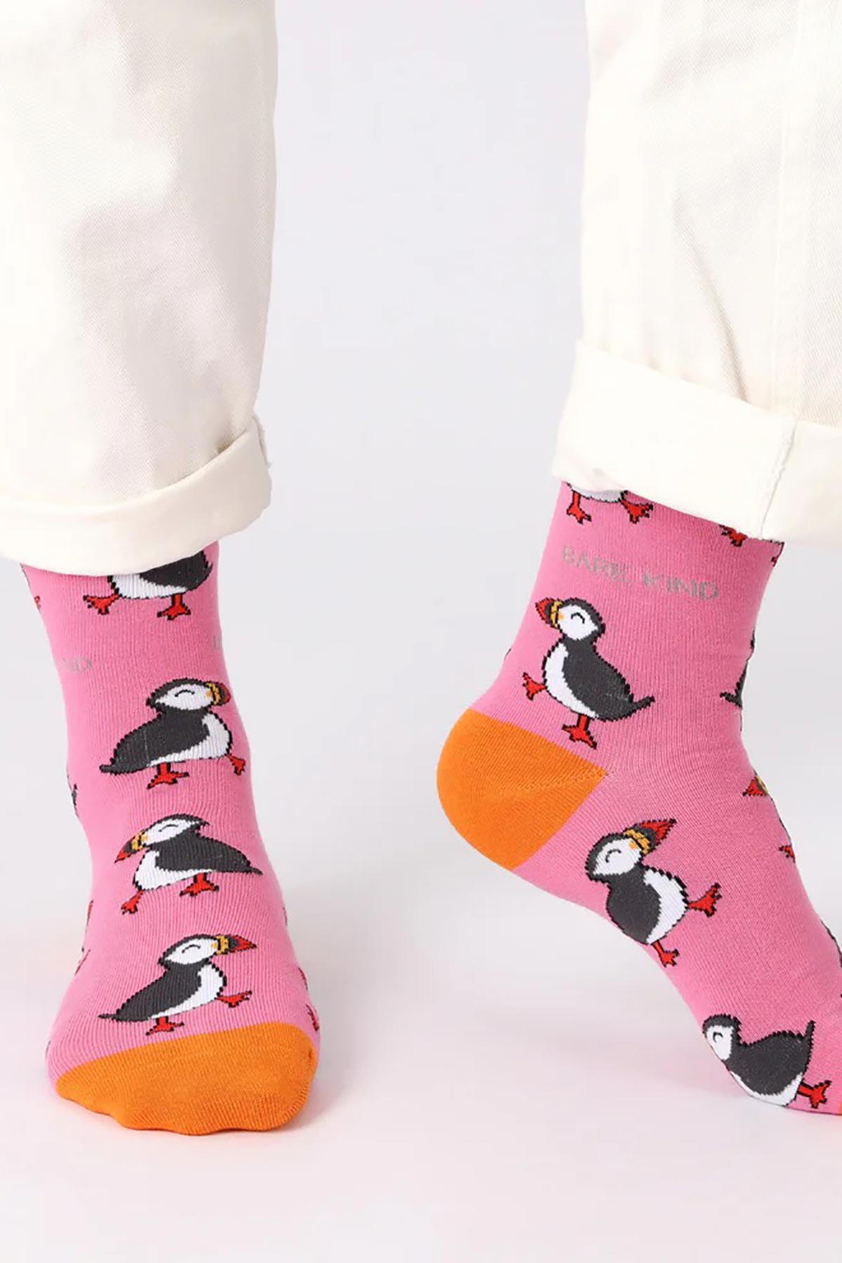 Model wearing pink puffin bamboo crew socks with cream trousers — Urban Wild