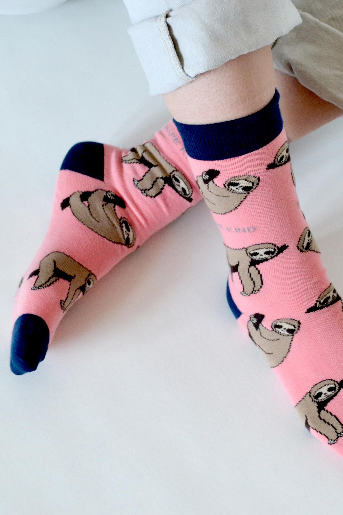 Pink bamboo sloth crew socks worn with rolled chino trousers — Urban Wild