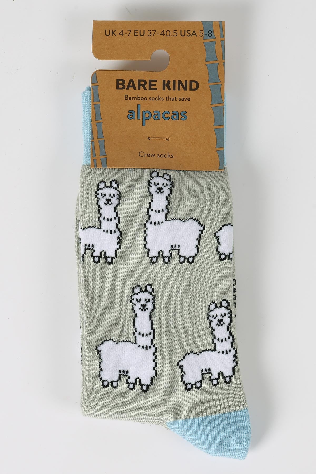 Sage green bamboo crew socks with white alpaca pattern in Bare Kind packaging — Urban Wild