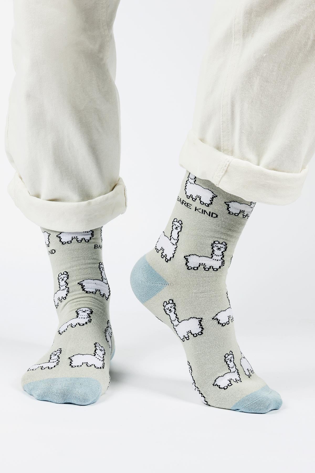 Sage green alpaca bamboo crew socks worn with cream trousers — Urban Wild