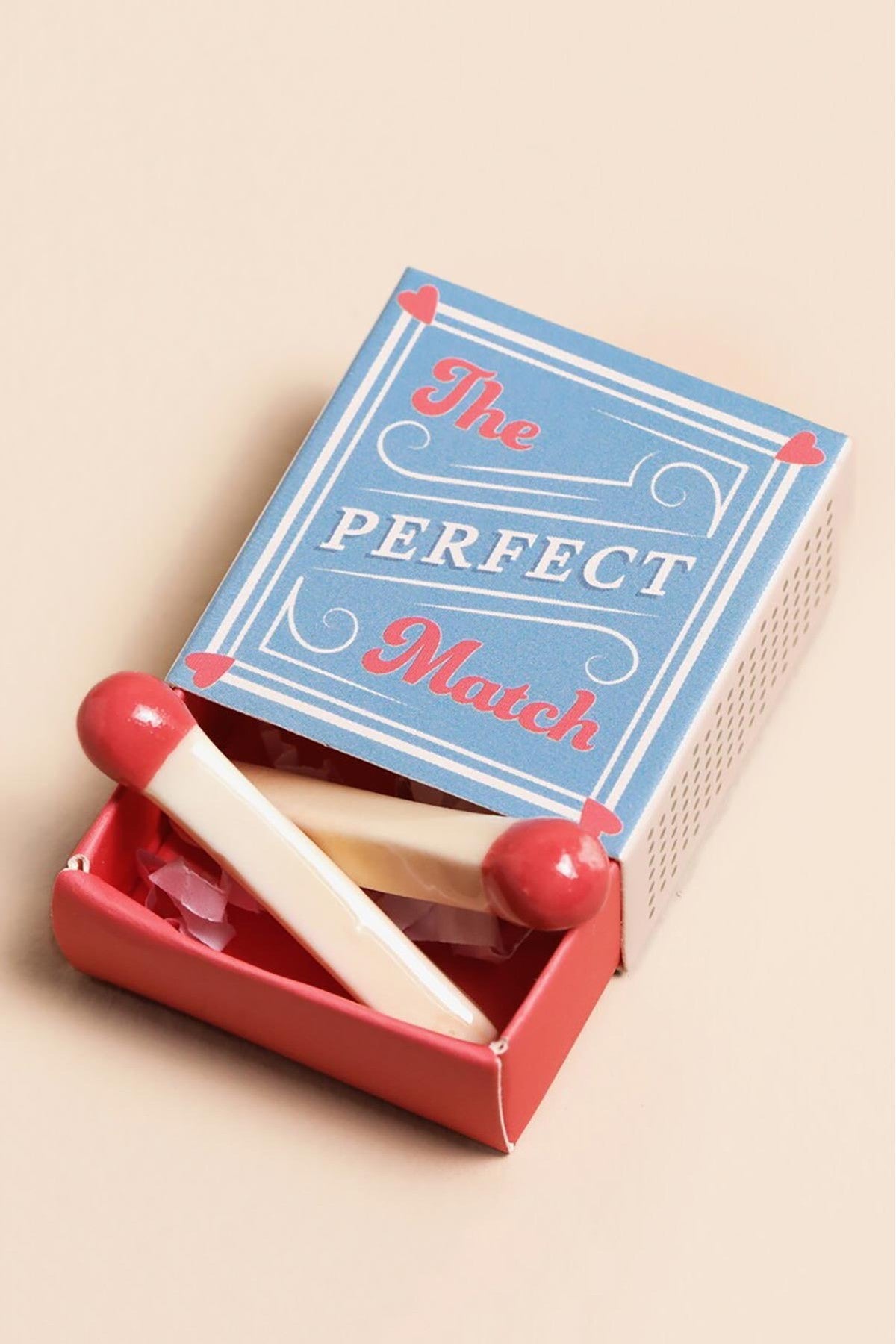 Tiny ceramic matchstick token with glossy red tip in mini matchbox — Urban Wild