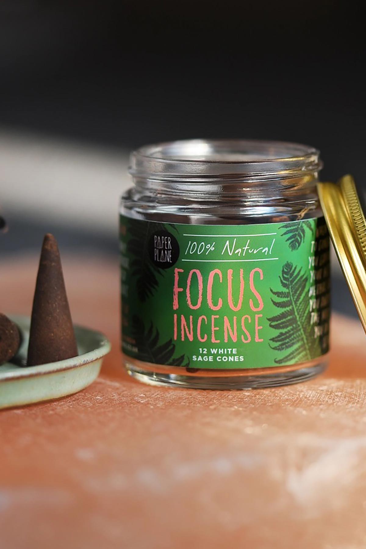 Open jar of Paper Plane white sage focus incense cones on terracotta surface — Urban Wild